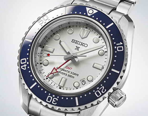 Close-up of Seiko Prospex GMT diver’s watch with white dial, blue rotating bezel and red GMT hand